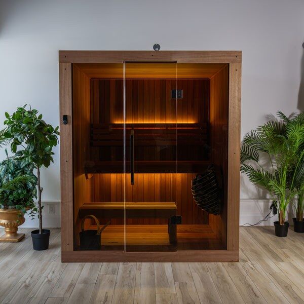 Element Studio indoor sauna with full glass front, two bench levels, optional lighting and heater (sold separately).