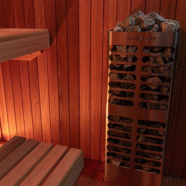 Element Studio indoor sauna close-up of a stone-filled heater (sold separately) beside wood benches.