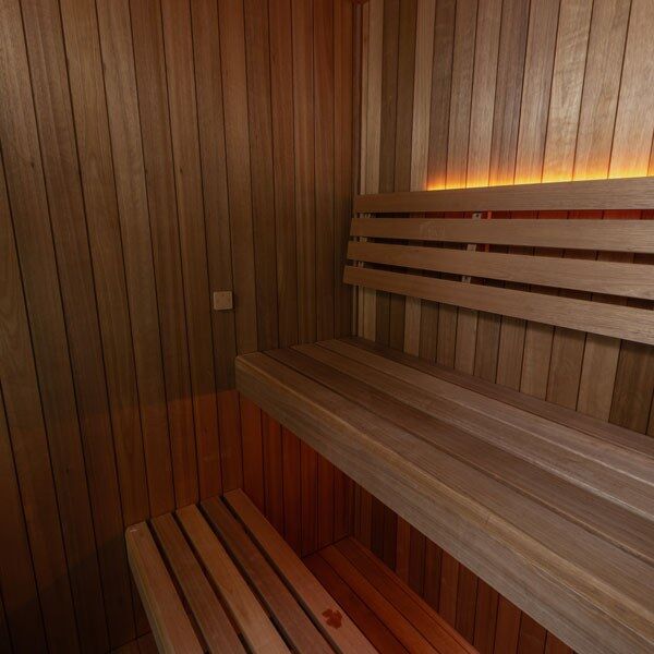 Element Loft indoor sauna interior with upper and lower wood benches, vertical wall boards and optional lighting
